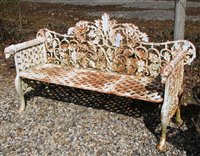 Lot 1035 - A cast iron white painted garden bench, the interlocked leaf decorated back above geometric pierced diamond seat on scrolled feet, 154cm wide, 56cm deep, 98cm high