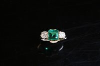 Lot 541 - A Colombian emerald and diamond three stone ring