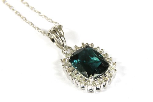 Lot 56 - An 18ct white gold tourmaline and diamond cluster pendant