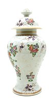 Lot 584 - A Samson baluster vase and cover decorated with an armorial amongst flower sprays, 40 cm high