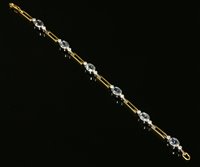 Lot 323 - An 18ct yellow and white gold aquamarine and diamond bracelet