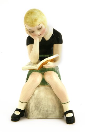 Lot 77 - A Goldscheider figure of a girl reading a book