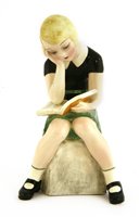 Lot 77 - A Goldscheider figure of a girl reading a book