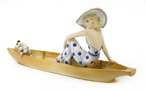 Lot 79 - A Goldscheider figure of a woman sitting in a boat with a terrier