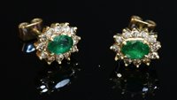 Lot 348 - A pair of gold, emerald and diamond oval cluster earrings