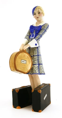 Lot 80 - A Goldscheider figure of a woman holding a hat box, holding two suitcases