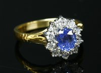 Lot 293 - An 18ct gold sapphire and diamond oval cluster ring