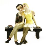 Lot 95 - A Lenci figure of a couple rested on a bench