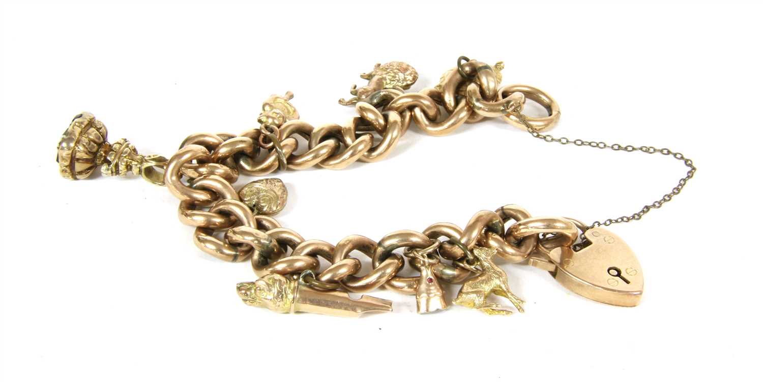Lot 18 - A 9ct gold hollow curb chain charm bracelet