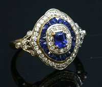 Lot 499 - A two colour gold sapphire and diamond target style cluster ring