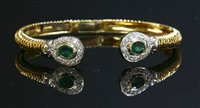 Lot 342 - An 18ct two colour gold emerald and diamond hinged torque bangle