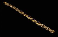 Lot 94 - An Edwardian gold and amethyst three bar gate bracelet