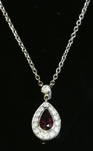 Lot 81 - An 18ct white gold ruby and diamond cluster pendant