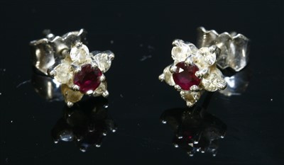 Lot 519 - A pair of 18ct white gold ruby and diamond cluster earrings