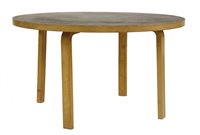 Lot 518 - A birch laminated circular table