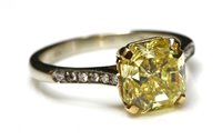 Lot 538 - A yellow and white gold single stone fancy vivid yellow diamond ring
