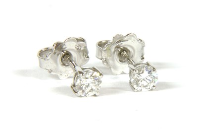 Lot 85 - A pair of white gold single stone diamond stud earrings
