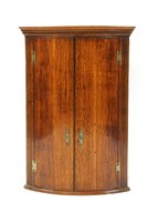 Lot 676 - A 19th century oak bow front hanging corner cupboard