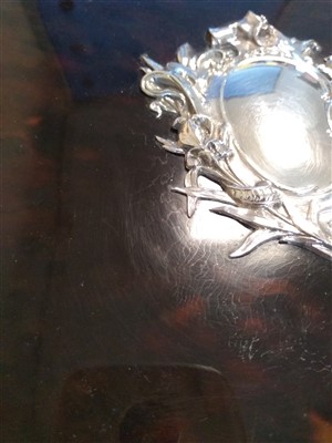 Lot 54 - A tortoiseshell desk blotter with ornate silver mounts