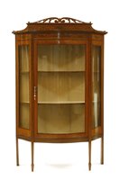 Lot 770 - An Edwardian satinwood and painted bow front display cabinet