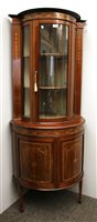 Lot 790 - An Edwardian bow front glazed corner cabinet