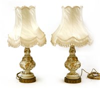 Lot 621 - A pair of milk glass and gilt decorated table lamps