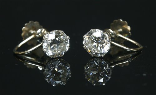 Lot 57 - A pair of single stone diamond stud earrings