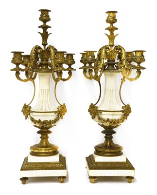 Lot 783 - A pair of gilt bronze and white marble five-branch candelabra