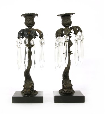 Lot 376 - A pair of cast dolphin candlesticks