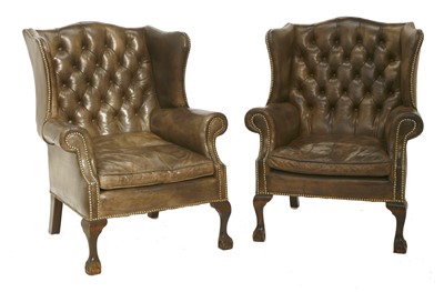 Lot 261 - A pair of George III-style wing back armchairs