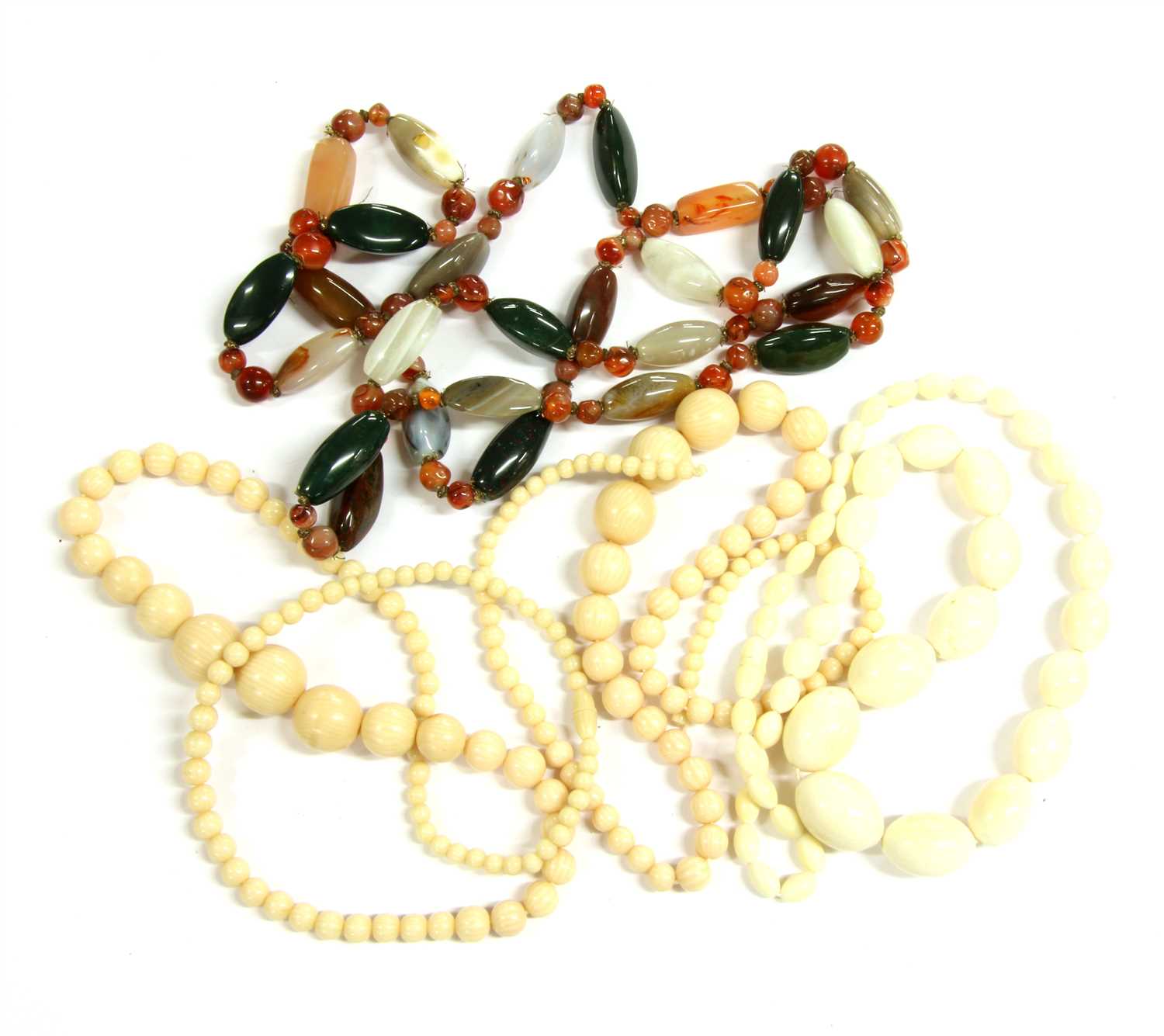 Lot 23 - A row of early 20th century olive shaped carved ivory beads