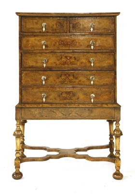 Lot 731 - A walnut chest on stand