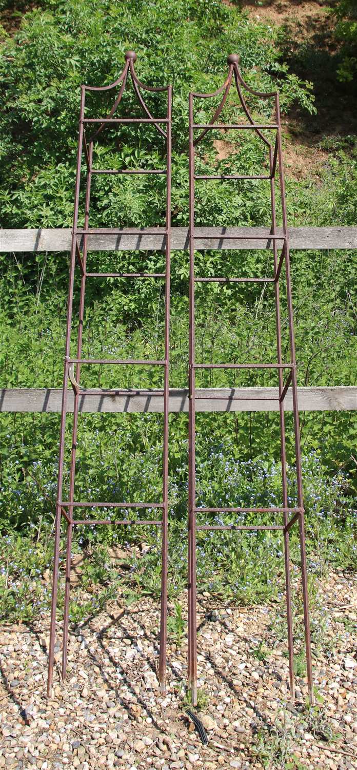 Lot 477 - A pair of hand forged wrought iron square section garden obelisks