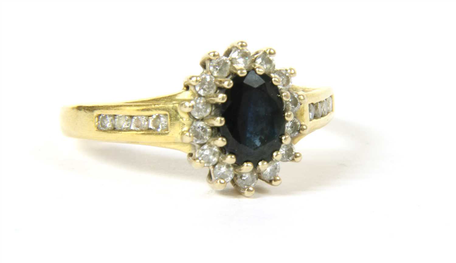 Lot 14 - An 18ct gold sapphire and diamond oval cluster ring