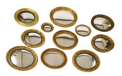 Lot 727 - A group of eleven Regency-style circular convex wall mirrors