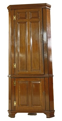 Lot 339 - An 18th century oak panelled standing corner cabinet