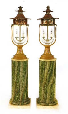 Lot 739 - A pair of lamps and columns