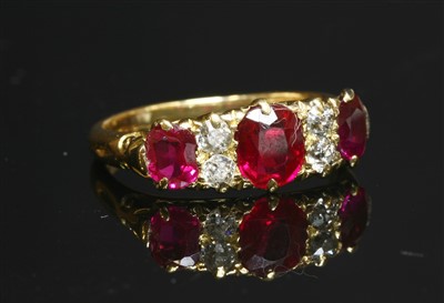 Lot 63 - An 18ct gold synthetic ruby and diamond carved head ring