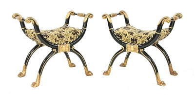 Lot 676 - A pair of Regency-style ebonised and parcel-gilt stools