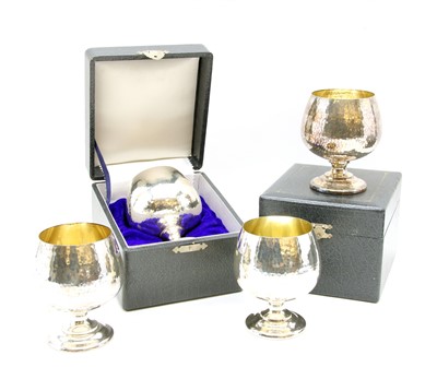 Lot 96 - A group of four planished goblets