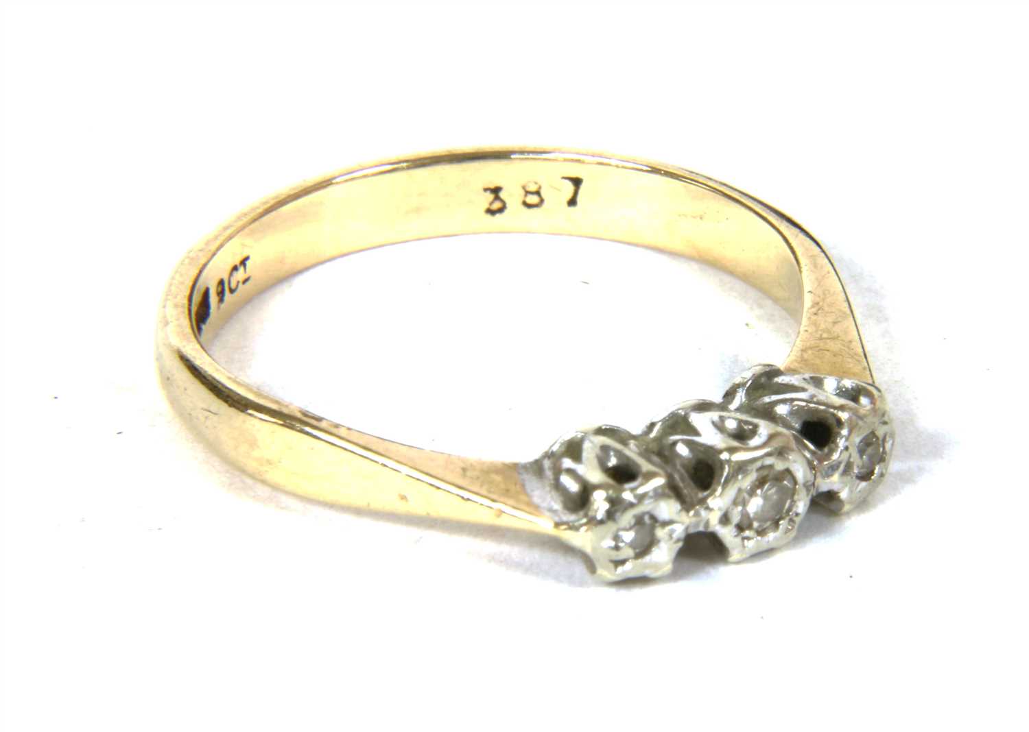 Lot 17 - A 9ct gold three stone diamond ring