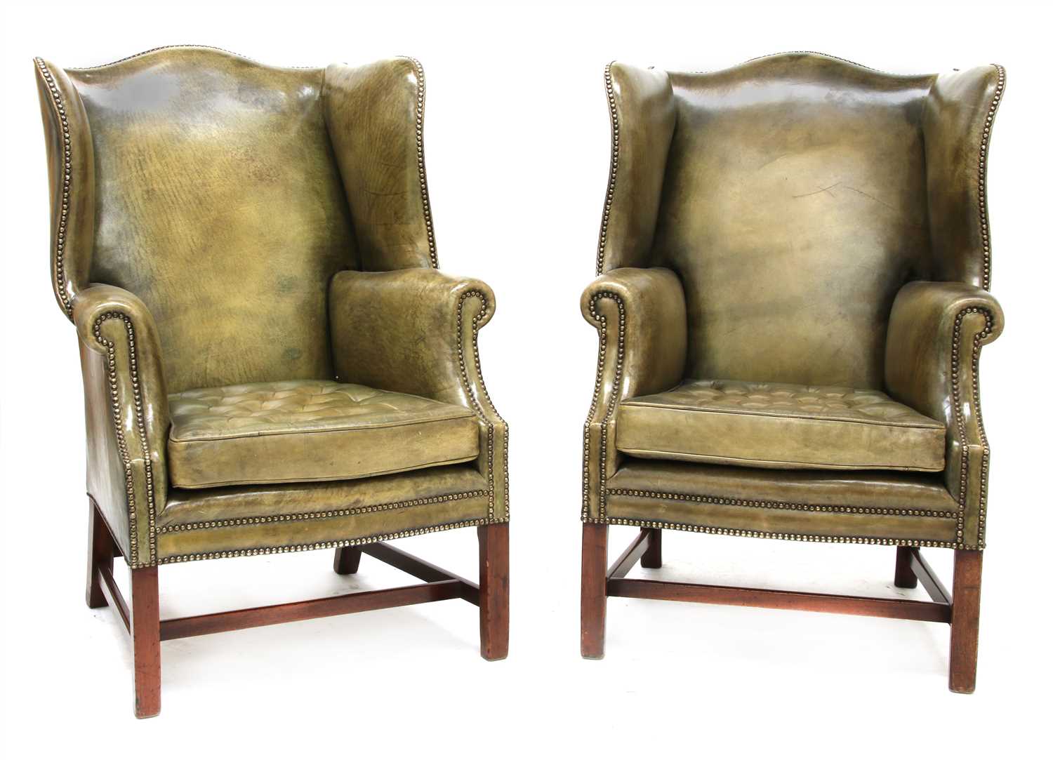 Lot 105 - A pair of George III-style wing armchairs