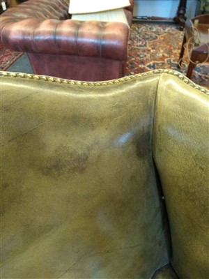 Lot 105 - A pair of George III-style wing armchairs