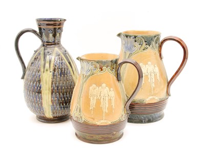 Lot 229 - A graduated pair of Doulton stoneware pitchers