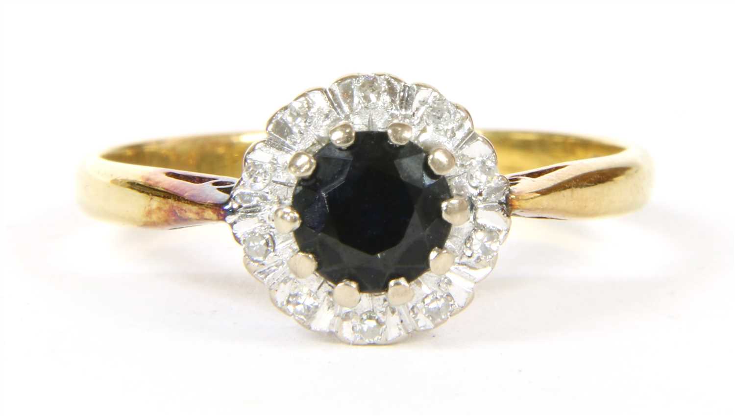 Lot 16 - A sapphire and diamond cluster ring