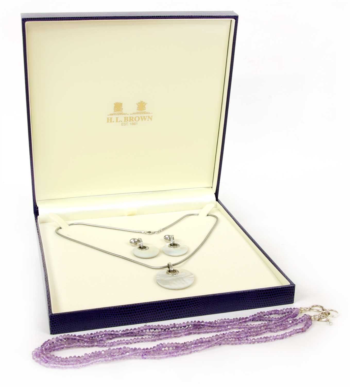 Lot 28 - A silver mounted three row amethyst bead necklace
