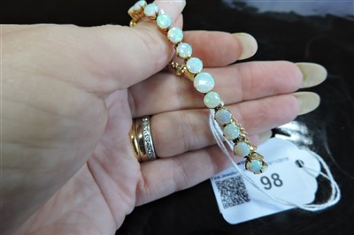 Lot 98 - An Edwardian gold opal bracelet