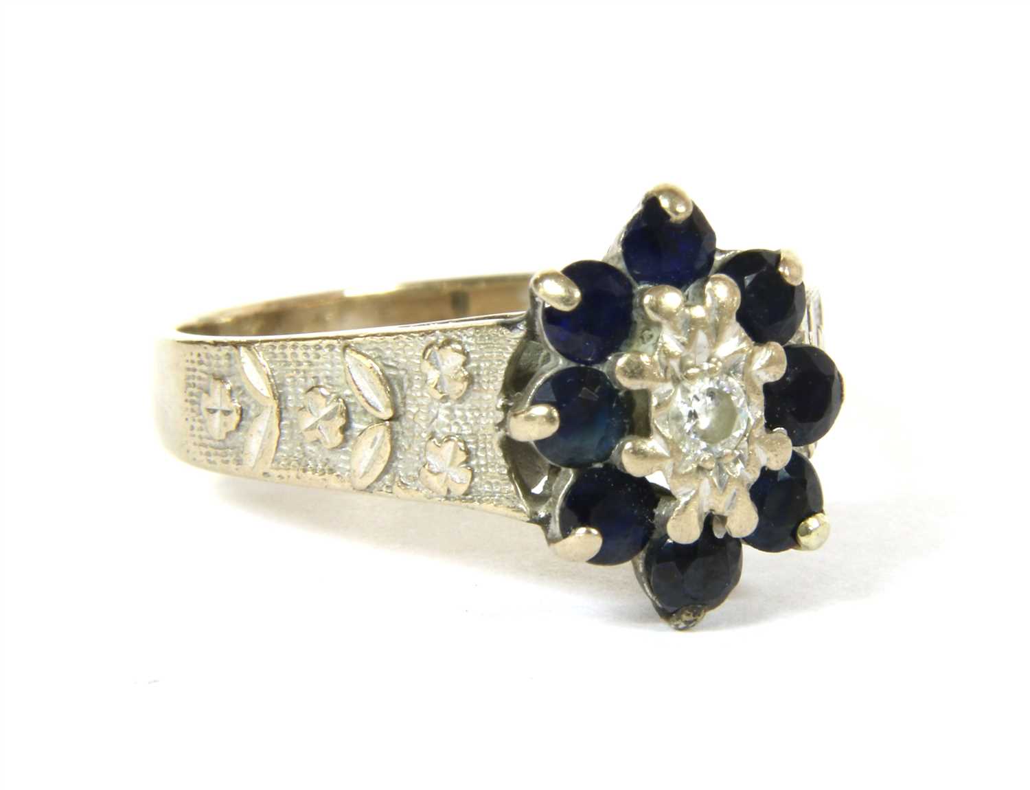 Lot 2 - An 18ct white gold diamond and sapphire oval cluster ring