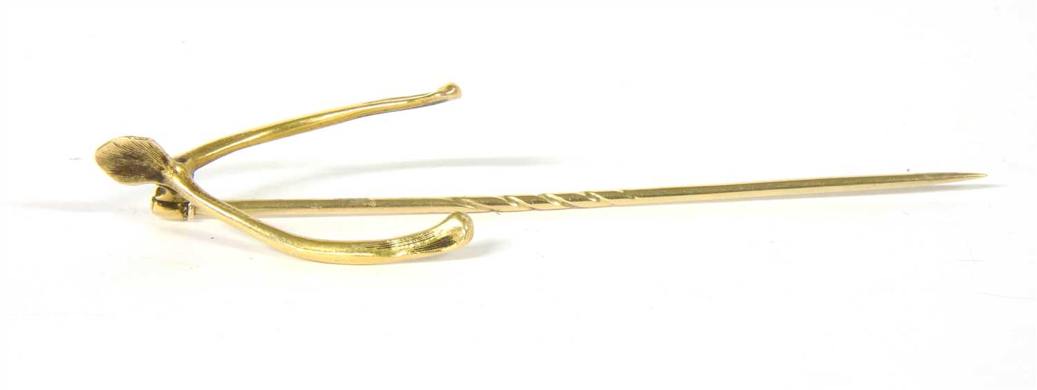 Lot 12 - A Victorian gold wishbone form stick pin