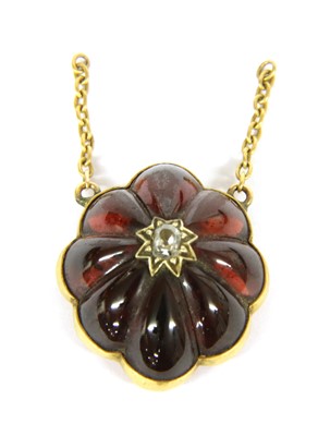Lot 25B - A Victorian gold diamond and carved garnet lobed pendant